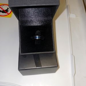 Men's Tungsten Shiny Black with a band of blue in the middle. Size 8